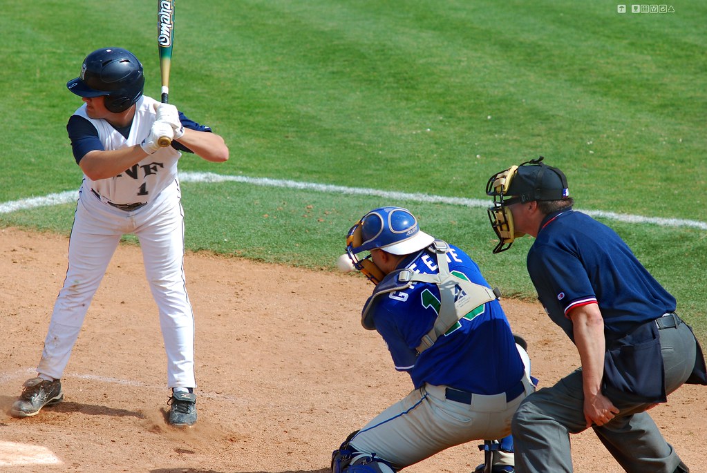 Batter, catcher, and umpire in live game action